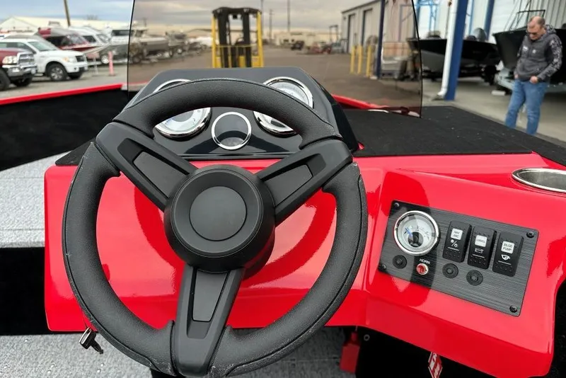 Slide: The Image of 2026 Smoker Craft Lazer 161 boat dashboard with steering wheel and control panel. - 7