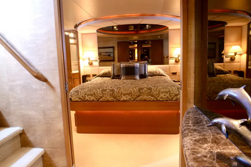 Slide: The Image of Luxurious bedroom interior on a 2000 Westport 112 yacht, featuring elegant decor and plush bedding. - 12