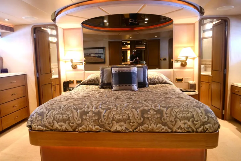 Slide: The Image of Luxurious bedroom interior of 2000 Westport 112 yacht with elegant bedding and warm lighting. - 13