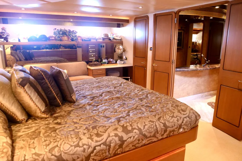 Slide: The Image of Luxurious bedroom interior on a 2000 Westport 112 yacht, featuring elegant decor and plush bedding. - 15