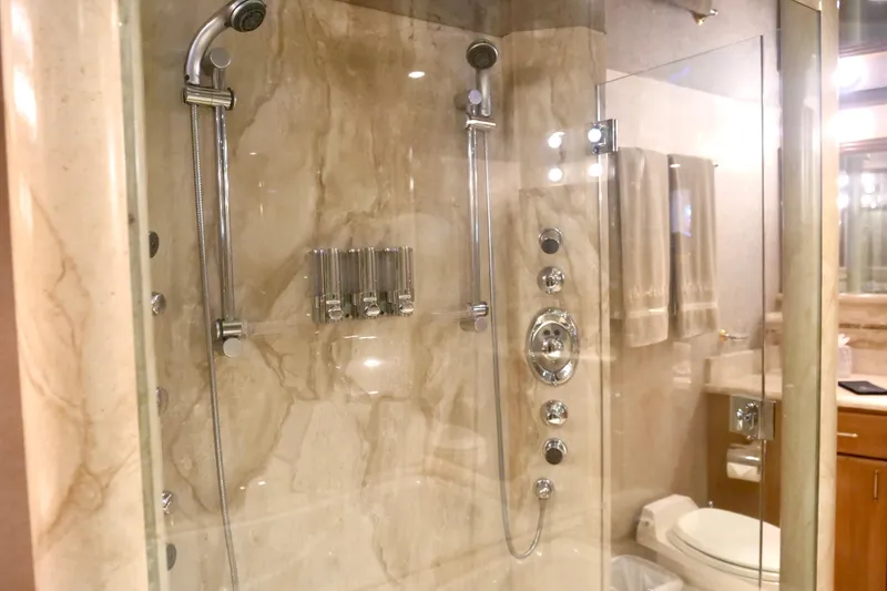 Slide: The Image of Luxurious marble shower in 2000 Westport 112 yacht bathroom, featuring modern fixtures and glass door. - 16