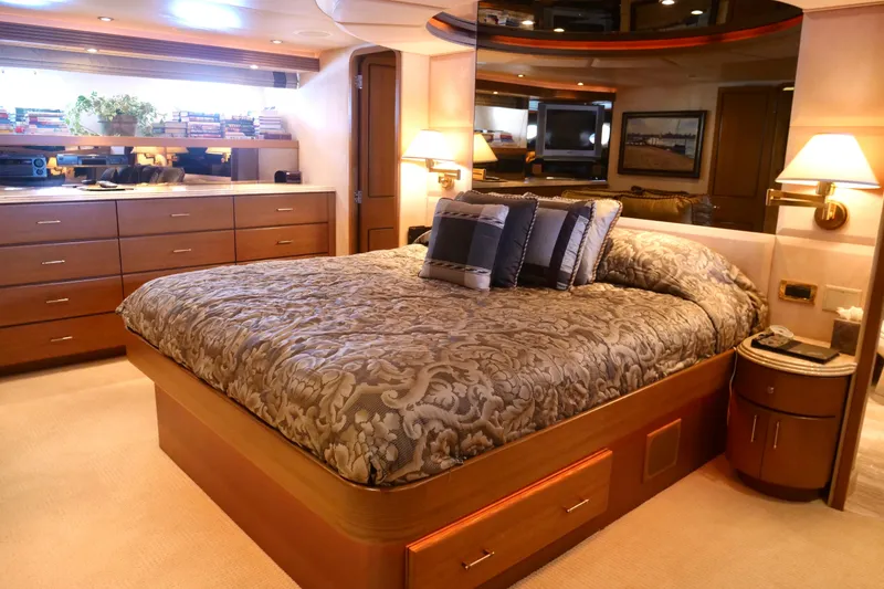 Slide: The Image of Luxurious bedroom interior on 2000 Westport 112 yacht, featuring elegant bedding and warm lighting. - 19