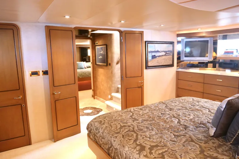 Slide: The Image of Luxurious Westport 112 yacht bedroom interior, featuring elegant wood finishes and modern amenities. - 22