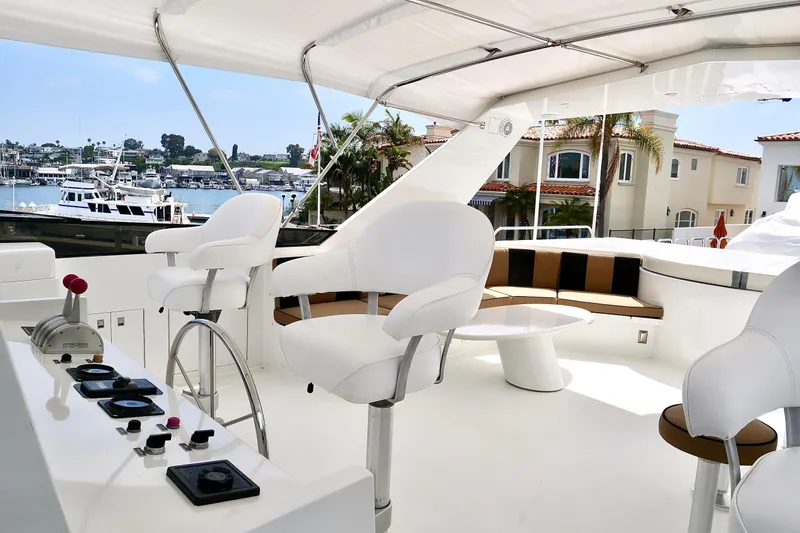 Slide: The Image of Luxurious 2000 Westport 112 yacht interior with white seating and marina view. - 24