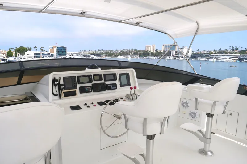 Slide: The Image of Helm of 2000 Westport 112 yacht with marina view, featuring modern navigation equipment. - 25