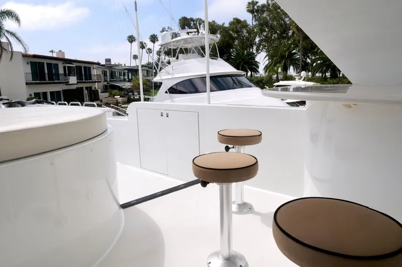 Slide: The Image of Luxurious 2000 Westport 112 yacht deck with bar stools and scenic marina view. - 29