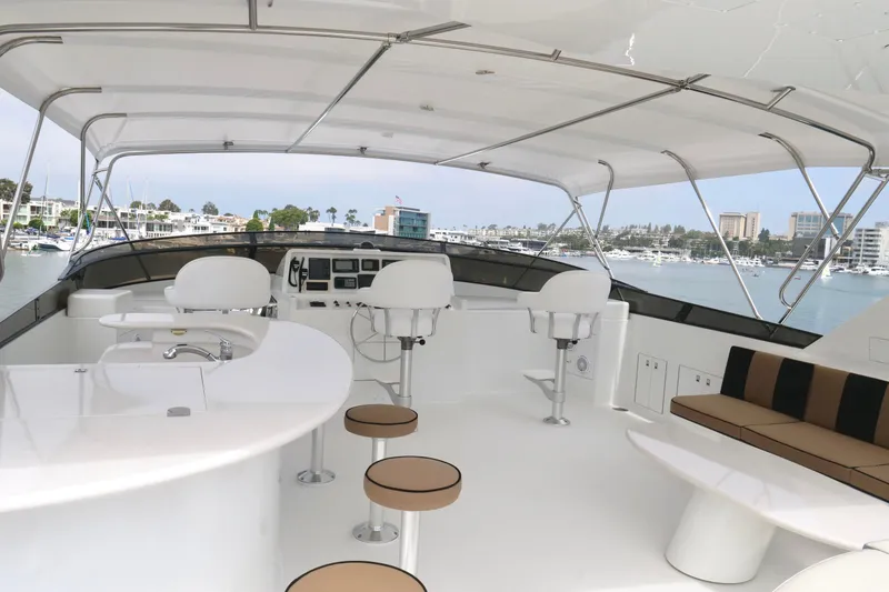 Slide: The Image of Luxurious 2000 Westport 112 yacht interior with seating and helm, overlooking marina. - 30