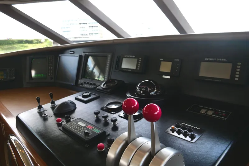 Slide: The Image of Control panel of a 2000 Westport 112 yacht with navigation instruments and throttle levers. - 35