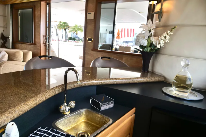 Slide: The Image of Luxurious interior of 2000 Westport 112 yacht with elegant bar and floral arrangement. - 36