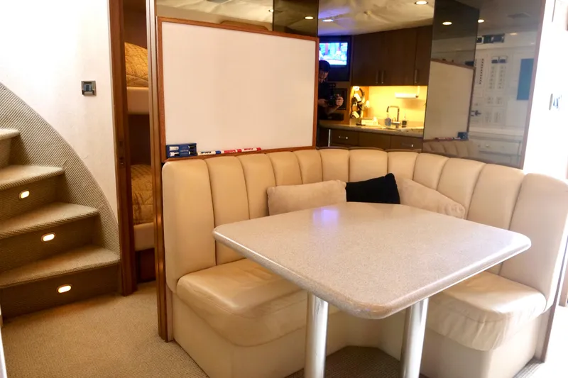 Slide: The Image of Luxurious interior of 2000 Westport 112 yacht with cozy dining area and staircase. - 39