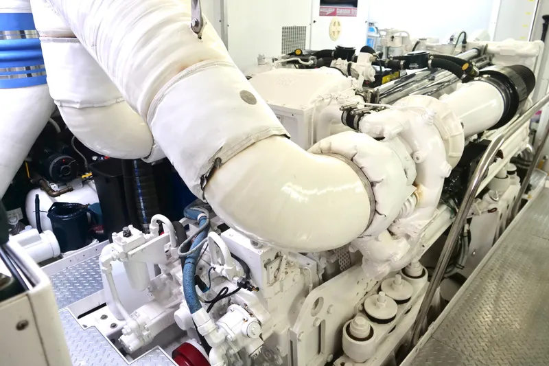 Slide: The Image of Engine room of a 2000 Westport 112 yacht, featuring complex machinery and piping. - 41