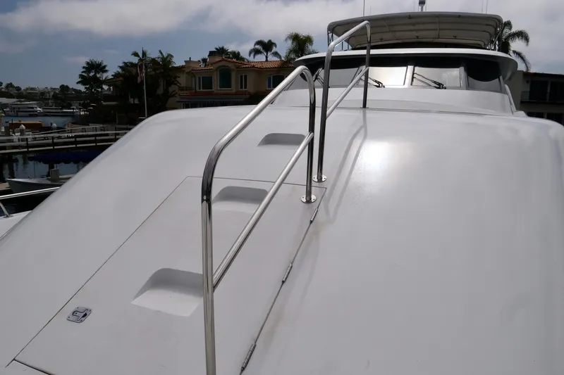 Slide: The Image of Luxury yacht Westport 112, 2000 model, with sleek white deck and stainless steel railings. - 5