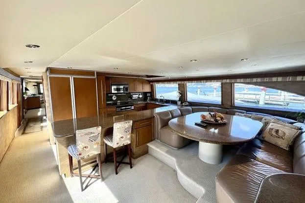 Slide: The Image of Luxurious interior of 2000 Westport 112 yacht with modern kitchen and dining area. - 59