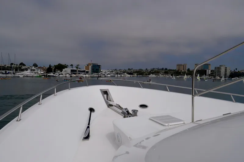 Slide: The Image of Bow view of 2000 Westport 112 yacht in a marina with cityscape background. - 6