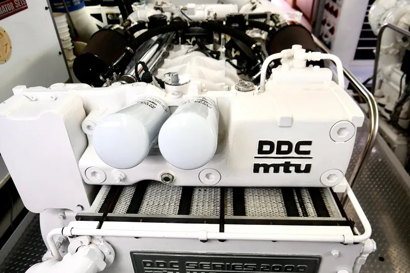 Slide: The Image of Engine room of a 2000 Westport 112 yacht featuring a DDC MTU engine. - 62