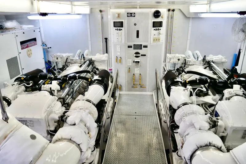 Slide: The Image of Engine room of a 2000 Westport 112 yacht, featuring dual engines and control panel. - 69