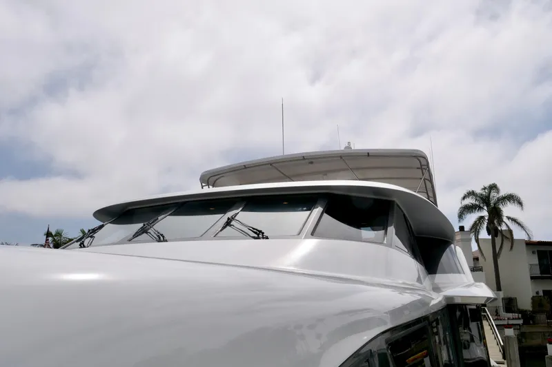 Slide: The Image of Luxury yacht Westport 112, 2000 model, docked under cloudy sky with palm trees. - 7