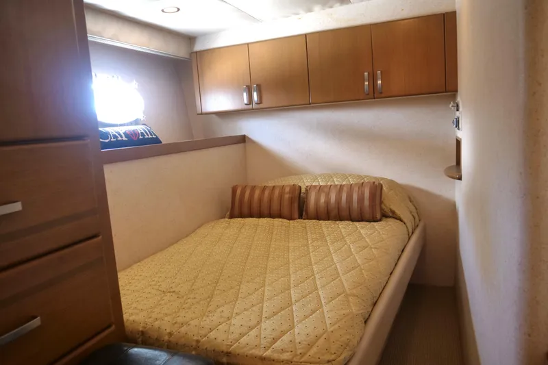 Slide: The Image of Cozy bedroom interior in 2000 Westport 112 yacht with wooden cabinets and soft lighting. - 70