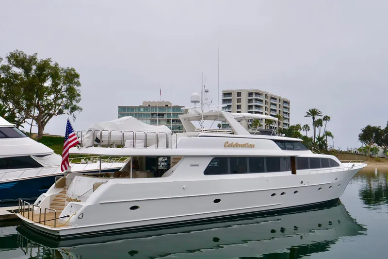 Slide: The Image of Luxury Westport 112 yacht from 2000 docked in a marina with cityscape background. - 71