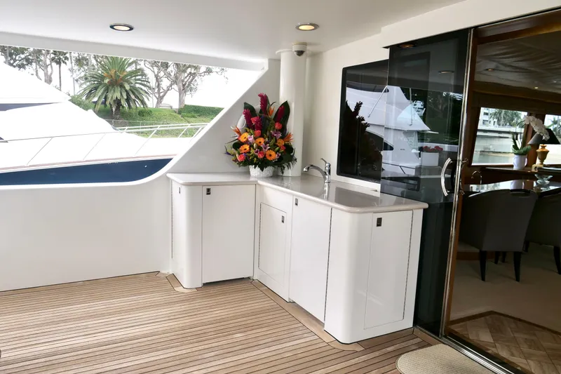 Slide: The Image of Luxurious Westport 112 yacht deck with elegant cabinetry and vibrant floral arrangement, year 2000 model. - 75