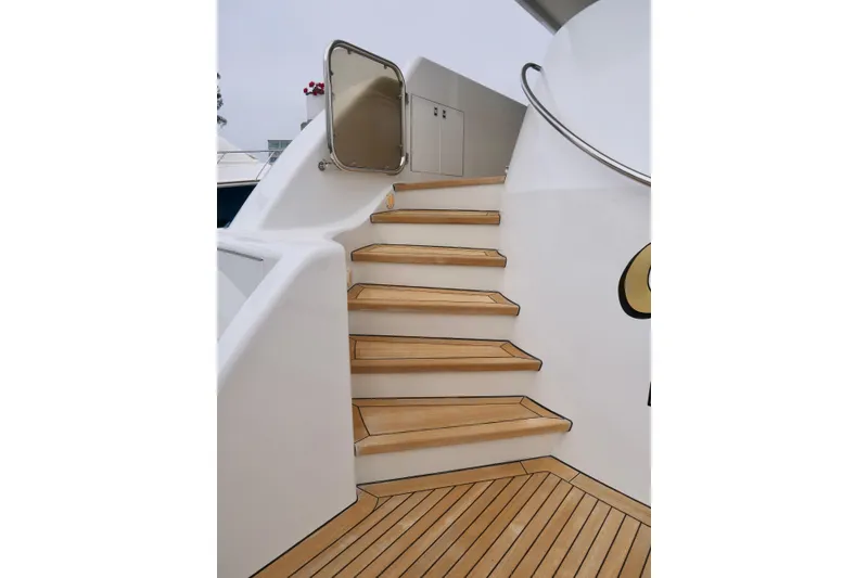 Slide: The Image of Staircase on 2000 Westport 112 yacht with teak steps and stainless steel railing. - 79