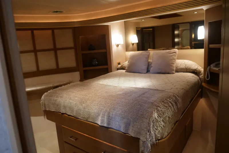 Slide: The Image of Luxurious bedroom interior of 2000 Westport 112 yacht with cozy bedding and ambient lighting. - 87