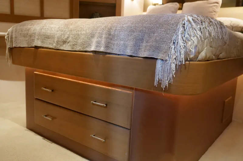 Slide: The Image of Luxurious Westport 112 yacht bedroom with elegant wooden bed frame and cozy bedding, 2000 model. - 88