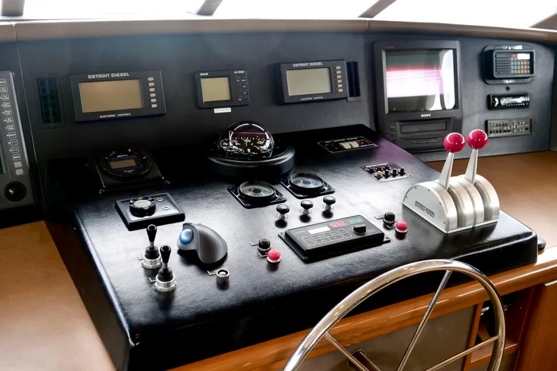 Slide: The Image of Control panel of a 2000 Westport 112 yacht with navigation instruments and throttle levers. - 90