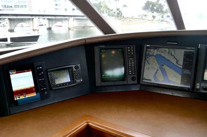 Slide: The Image of Control panel of a 2000 Westport 112 yacht with navigation screens and instruments. - 91