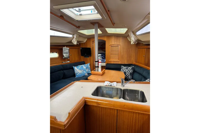 Slide: The Image of Interior of 2003 Hunter 356 sailboat with cozy seating and wooden finishes. - 13