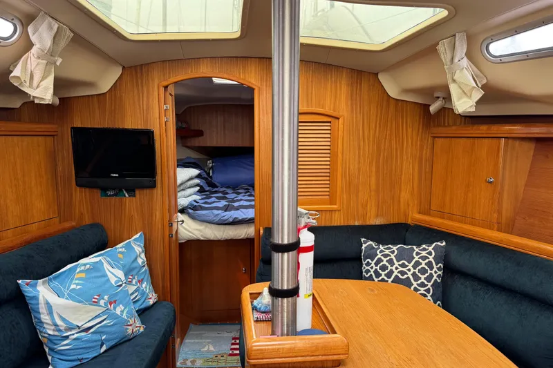 Slide: The Image of Cozy interior of 2003 Hunter 356 sailboat with wood paneling and seating area. - 15