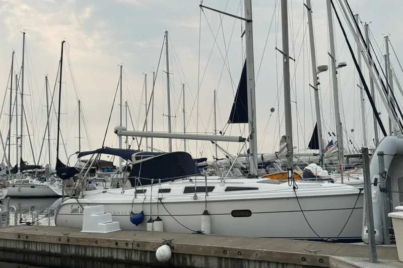 Slide: The Image of Sailboat Hunter 356, 2003 model, docked at marina with other sailboats. - 2