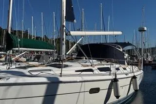 Slide: The Image of 2003 Hunter 356 sailboat docked in a marina under clear blue skies. - 3