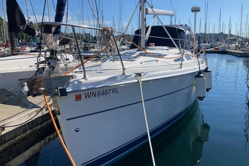 Slide: The Image of 2003 Hunter 356 sailboat docked in marina, registration WN6467RL, with clear blue sky. - 4