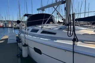 Slide: The Image of 2003 Hunter 356 sailboat docked at marina under clear blue sky. - 5