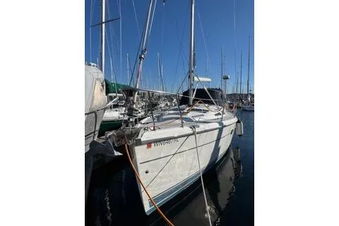 Slide: The Image of 2003 Hunter 356 sailboat docked in a marina, surrounded by other boats. - 7