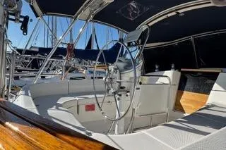 Slide: The Image of Cockpit of 2003 Hunter 356 sailboat with steering wheel and seating area. - 8