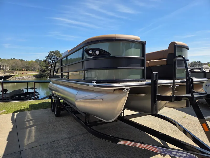 Slide: The Image of 2026 Bentley Pontoons Legacy 223 Swingback on trailer by the water. - 3