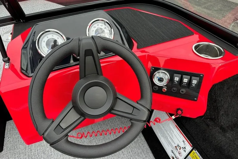 Slide: The Image of Steering wheel and dashboard of 2026 Smoker Craft Lazer 162 boat, featuring red accents. - 8