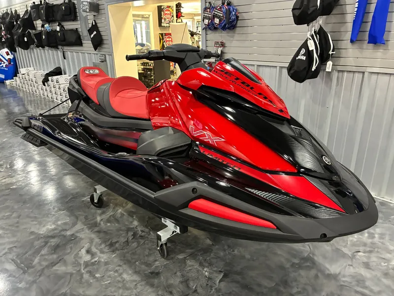 The Image of 2024 Yamaha VX Limited jet ski in red and black in showroom. - 1