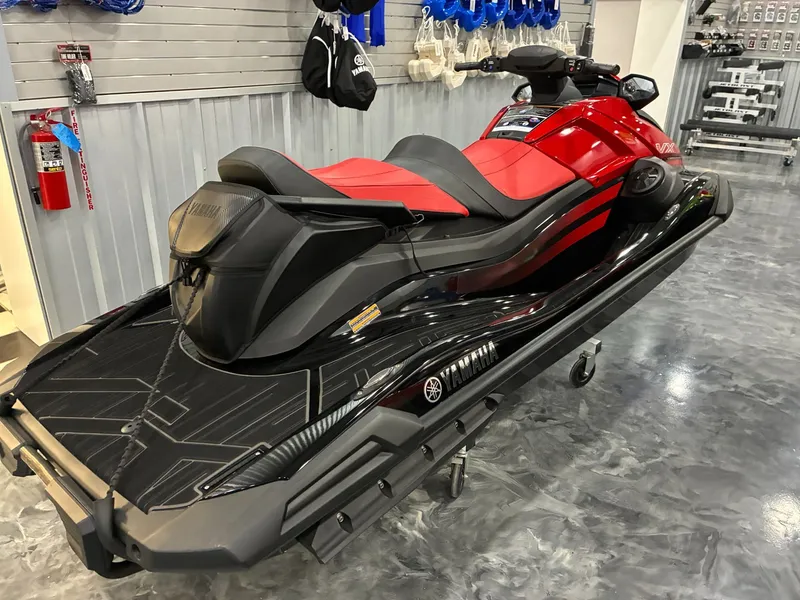 Slide: The Image of 2024 Yamaha VX Limited jet ski in red and black in showroom. - 4