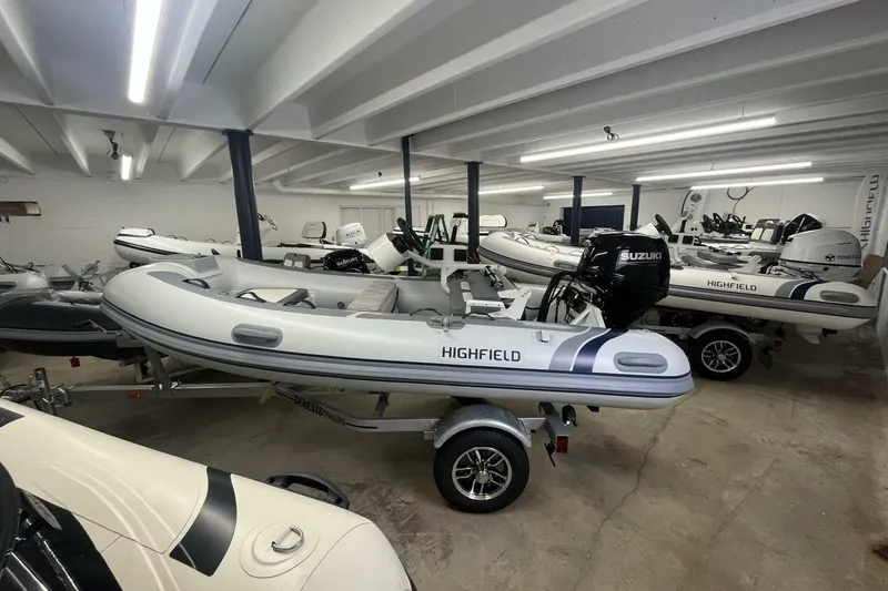 The Image of 2026 Highfield Classic 340 inflatable boats in showroom, featuring Suzuki outboard motors. - 1