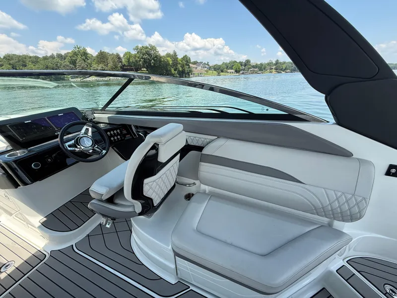 Slide: The Image of 2023 Sea Ray SLX 260 Surf boat interior with modern helm and luxurious seating. - 18