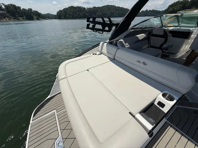 Slide: The Image of 2023 Sea Ray SLX 260 Surf boat with spacious seating on a serene lake. - 22