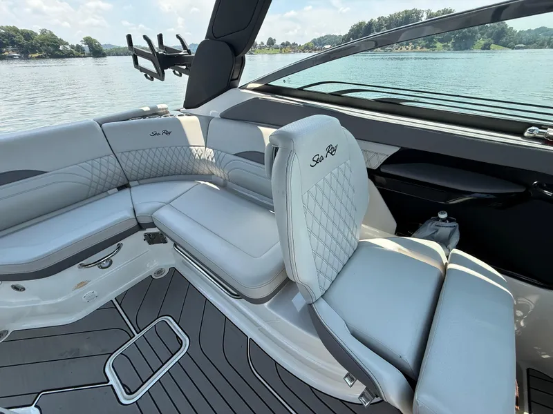 Slide: The Image of 2023 Sea Ray SLX 260 Surf boat interior with luxurious seating and lake view. - 23
