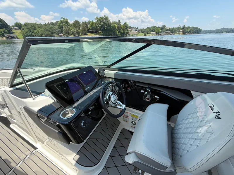 Slide: The Image of 2023 Sea Ray SLX 260 Surf boat interior with modern dashboard and steering wheel. - 24