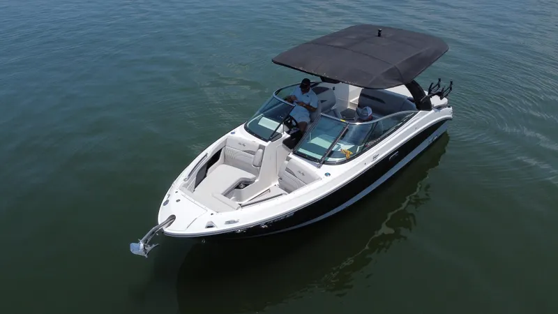 Slide: The Image of 2023 Sea Ray SLX 260 Surf boat on calm water, featuring sleek design and spacious seating. - 6