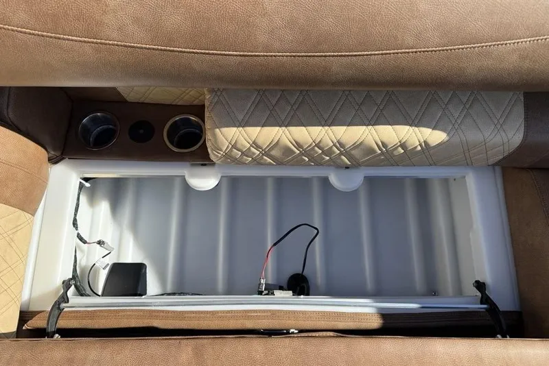 Slide: The Image of Interior storage compartment of 2026 Premier 330 Escalante with cup holders and wiring. - 10