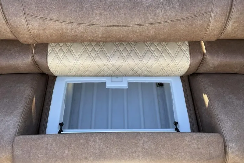 Slide: The Image of 2026 Premier 330 Escalante boat seat with storage compartment, featuring brown upholstery. - 17