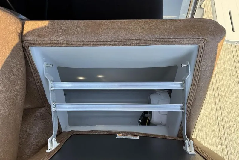 Slide: The Image of Open storage compartment in 2026 Premier 330 Escalante boat with brown upholstery. - 23
